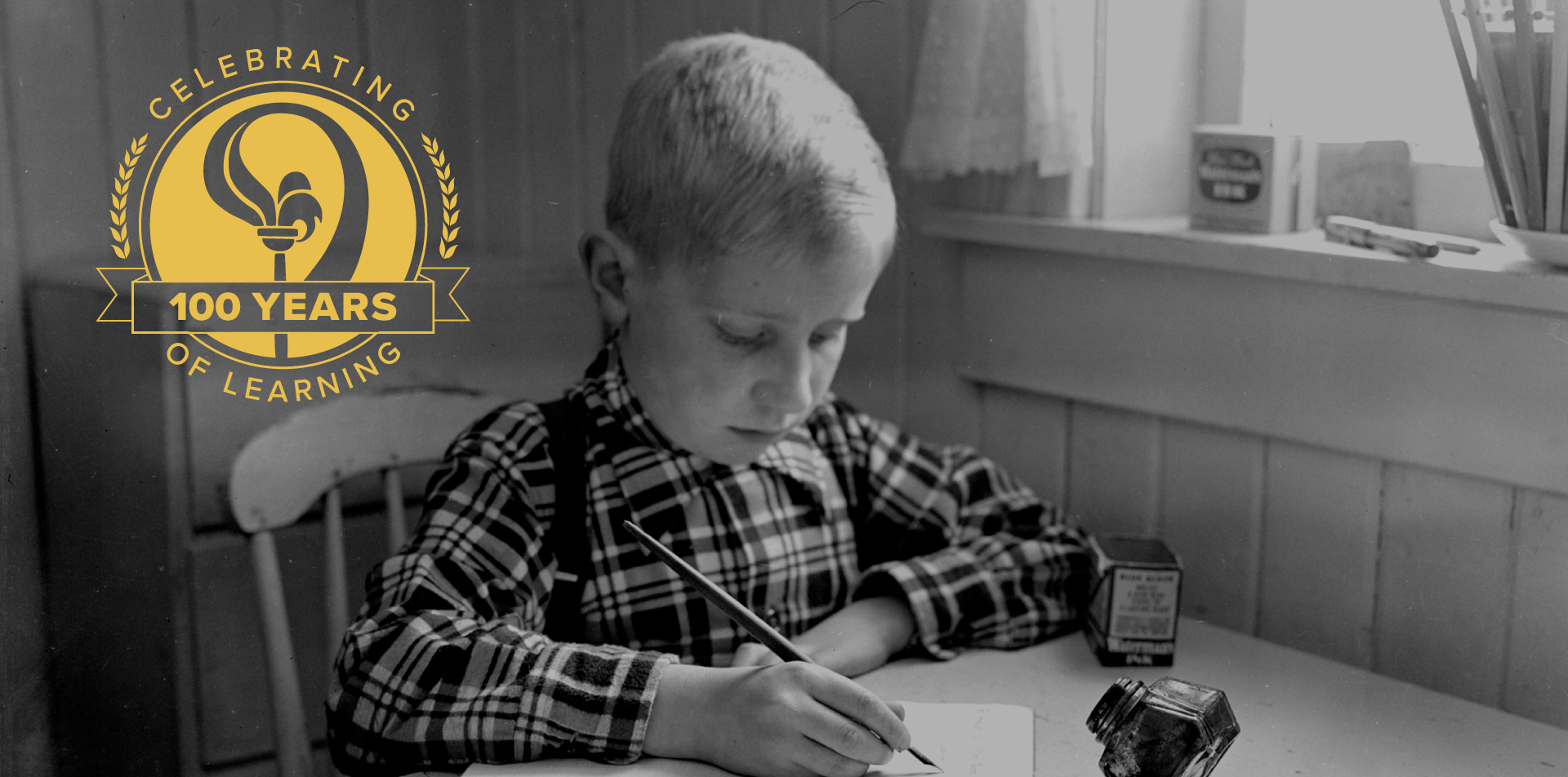 100 years boy at writing desk
